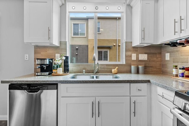 kitchen with a sink, backsplash, dishwasher, and white cabinets