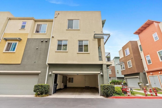 townhome / multi-family property featuring a garage and stucco siding