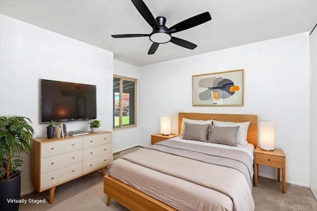 bedroom with baseboards, ceiling fan, and light carpet