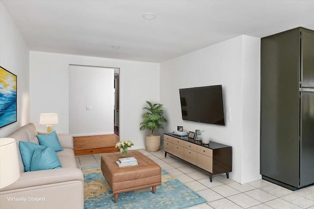 living room featuring baseboards and light tile patterned floors