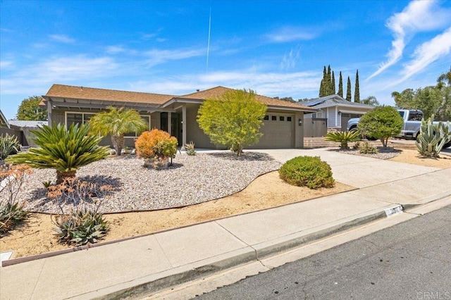 single story home featuring stucco siding, driveway, and a garage