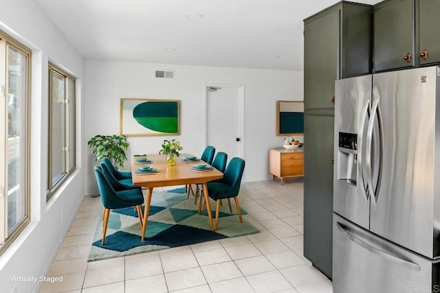 dining area featuring visible vents and light tile patterned flooring