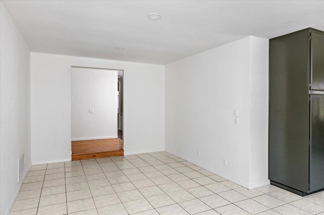 unfurnished room with visible vents