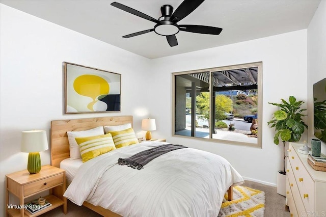 carpeted bedroom with baseboards and a ceiling fan