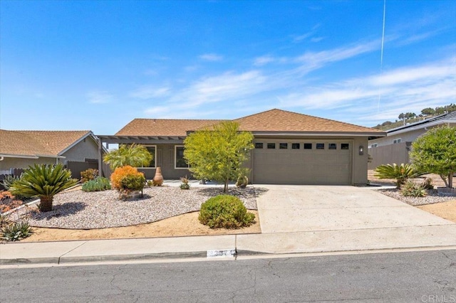 ranch-style house featuring concrete driveway, stucco siding, and a garage
