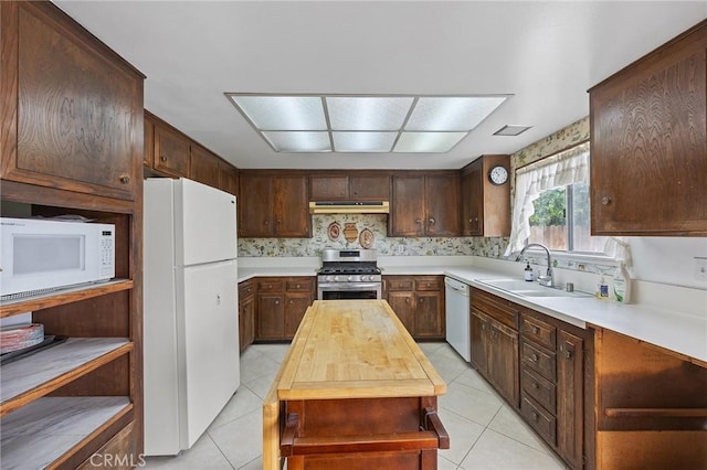 23692 Cavanaugh Rd, Lake Forest, CA 92630 - kitchen with white appliances, under cabinet range hood, a sink, light tile patterned flooring, and wood counters
