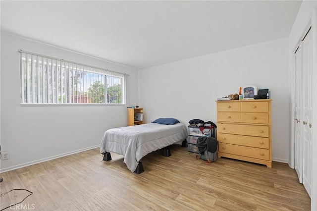 23692 Cavanaugh Rd, Lake Forest, CA 92630 - bedroom with light wood-type flooring, a closet, and baseboards