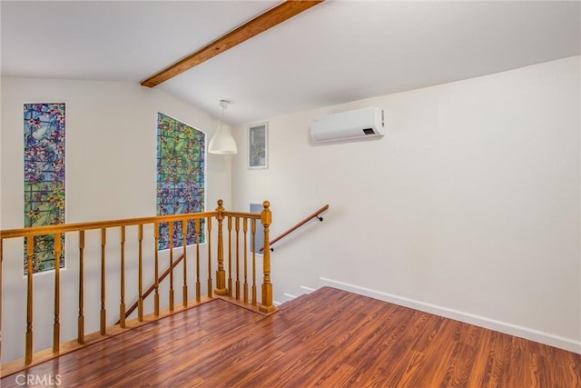staircase featuring lofted ceiling with beams, a wall mounted air conditioner, baseboards, wood finished floors, and visible vents