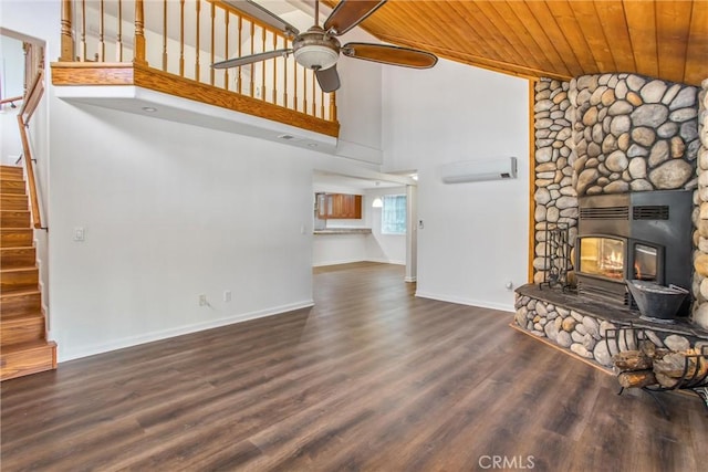 unfurnished living room with stairs, a ceiling fan, wood finished floors, a wall mounted AC, and wood ceiling