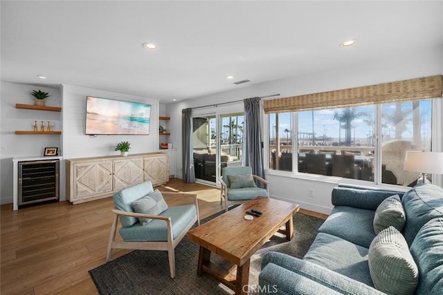 living room featuring wine cooler, recessed lighting, wood finished floors, and visible vents