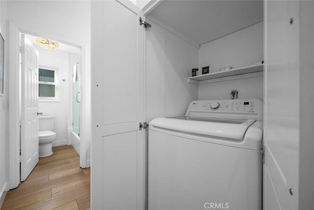 washroom featuring light wood-type flooring, laundry area, and washer / clothes dryer