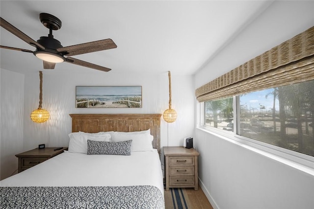 bedroom with baseboards and wood finished floors