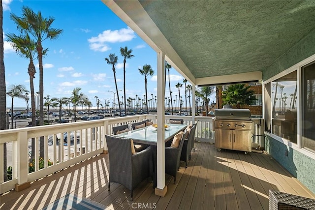 deck featuring area for grilling and outdoor dining space