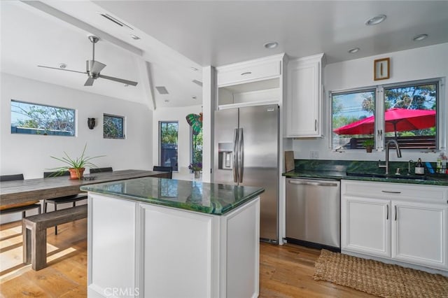 kitchen with a sink, appliances with stainless steel finishes, a wealth of natural light, and ceiling fan