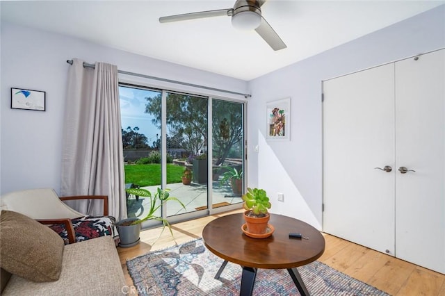sitting room featuring light wood-style flooring and ceiling fan