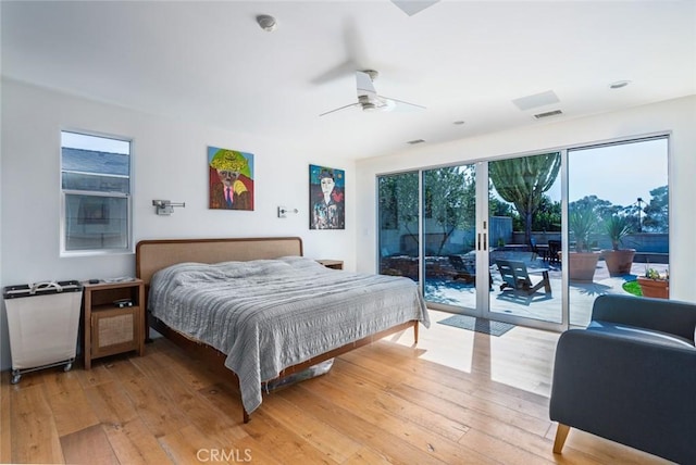bedroom with visible vents, a ceiling fan, light wood-style flooring, and access to exterior