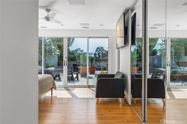 entryway with french doors, a ceiling fan, visible vents, and hardwood / wood-style flooring