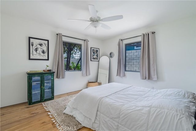 bedroom with ceiling fan and wood finished floors