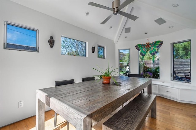 dining space featuring visible vents, lofted ceiling with beams, light wood-style flooring, and ceiling fan
