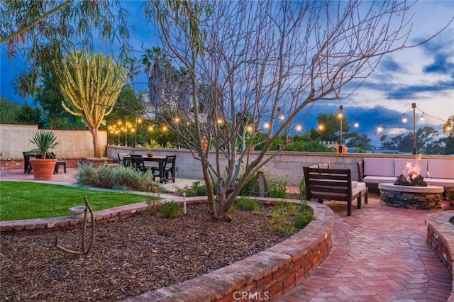 surrounding community with fence, a patio area, and an outdoor living space with a fire pit
