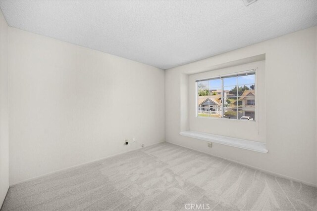41880 Humber Dr, Temecula, CA 92591 - empty room featuring a textured ceiling and light colored carpet