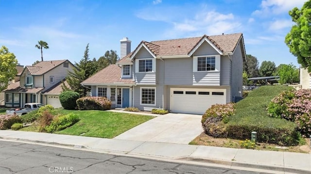 41880 Humber Dr, Temecula, CA 92591 - traditional home with an attached garage, concrete driveway, a tile roof, a chimney, and a front lawn