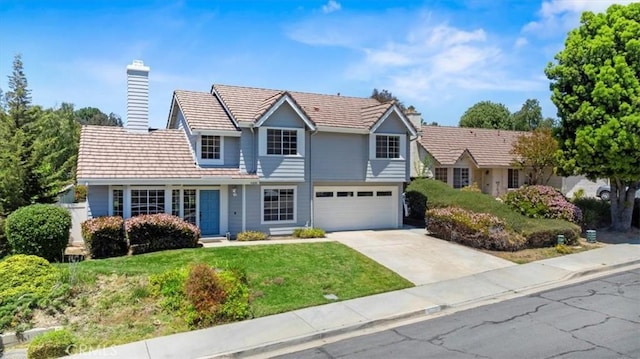 41880 Humber Dr, Temecula, CA 92591 - traditional-style house featuring a chimney, concrete driveway, an attached garage, and a front yard
