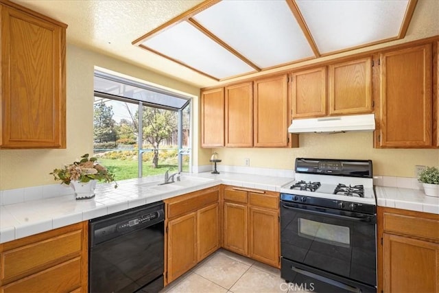 41880 Humber Dr, Temecula, CA 92591 - kitchen with range with gas stovetop, black dishwasher, under cabinet range hood, a sink, and light tile patterned floors