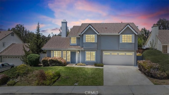 41880 Humber Dr, Temecula, CA 92591 - traditional-style home with a yard, concrete driveway, a tile roof, a chimney, and an attached garage