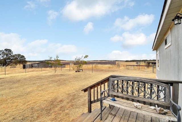 deck featuring a rural view and fence