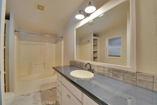 full bathroom with visible vents, vanity, toilet,  shower combination, and backsplash