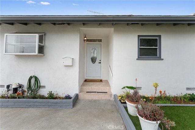 entrance to property with stucco siding