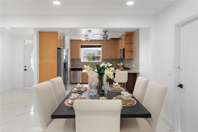 dining space with marble finish floor, baseboards, and recessed lighting