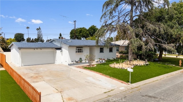 ranch-style house featuring fence, an attached garage, stucco siding, concrete driveway, and a front yard