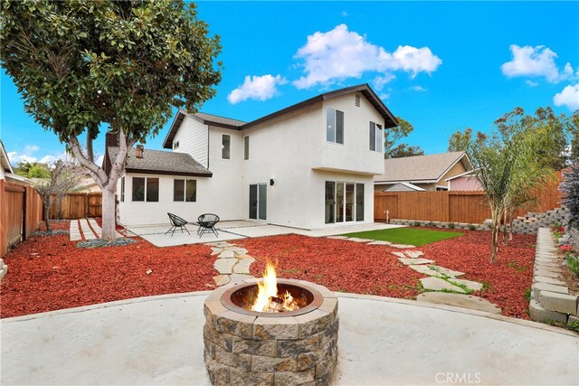 29282 Sonoma Way, San Juan Capistrano, CA 92675 - rear view of house featuring a patio, a fenced backyard, an outdoor fire pit, and stucco siding