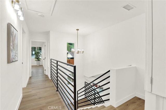 29282 Sonoma Way, San Juan Capistrano, CA 92675 - corridor with visible vents, light wood-type flooring, baseboards, an upstairs landing, and an inviting chandelier