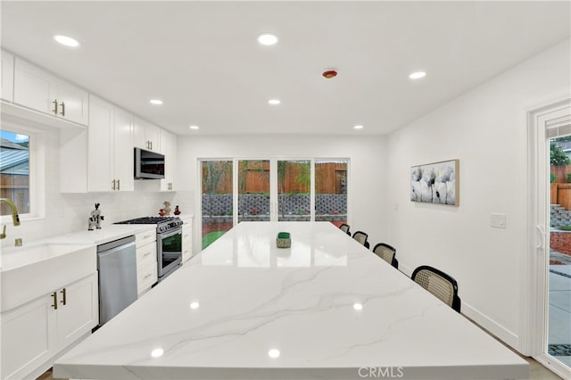 29282 Sonoma Way, San Juan Capistrano, CA 92675 - kitchen featuring stainless steel appliances, plenty of natural light, a sink, and a center island