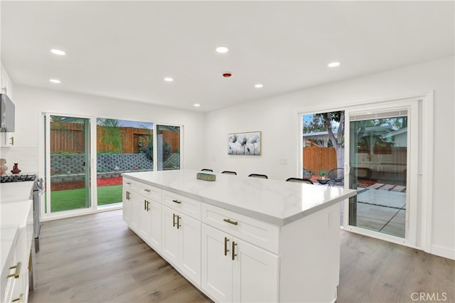 29282 Sonoma Way, San Juan Capistrano, CA 92675 - kitchen with recessed lighting, a center island, white cabinets, and light wood-type flooring
