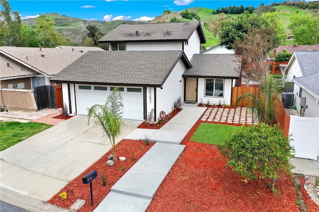 29282 Sonoma Way, San Juan Capistrano, CA 92675 - view of front facade with fence, a mountain view, driveway, and a garage