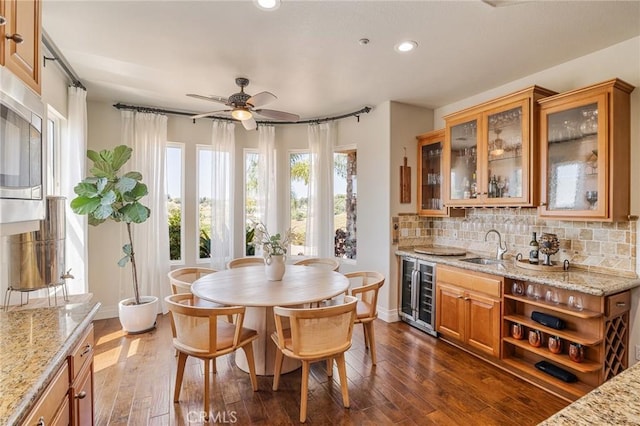 3863 Flowerwood Ln, Fallbrook, CA 92028 - dining space featuring wine cooler, bar with sink, recessed lighting, dark wood-style flooring, and a ceiling fan