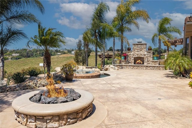 3863 Flowerwood Ln, Fallbrook, CA 92028 - view of patio / terrace featuring an outdoor stone fireplace and an in-ground hot tub