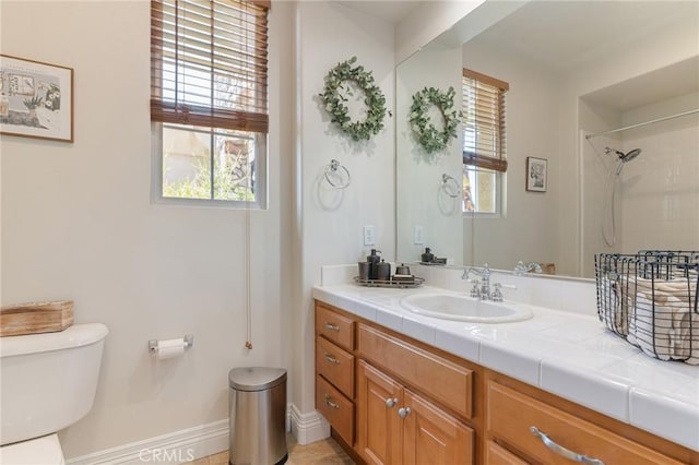 3863 Flowerwood Ln, Fallbrook, CA 92028 - bathroom with toilet, vanity, baseboards, and a shower