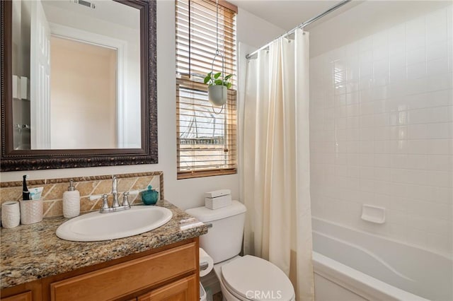 bathroom featuring vanity, toilet, and shower / tub combo with curtain