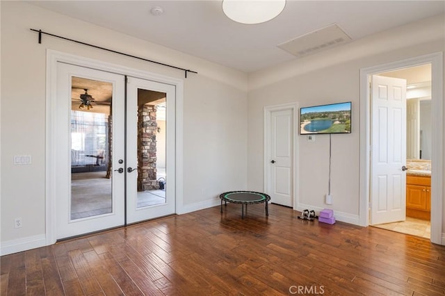 doorway featuring baseboards, wood-type flooring, french doors, and visible vents