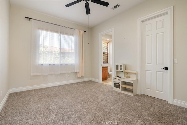 bedroom featuring baseboards, light carpet, and visible vents