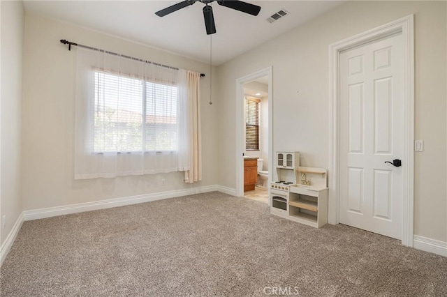 3863 Flowerwood Ln, Fallbrook, CA 92028 - carpeted bedroom with baseboards, ensuite bath, and ceiling fan