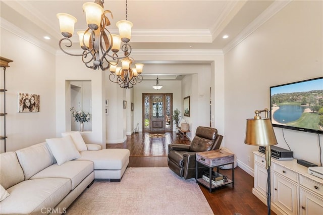 living room featuring crown molding, baseboards, an inviting chandelier, and dark wood-style floors