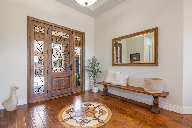 foyer featuring baseboards and hardwood / wood-style floors