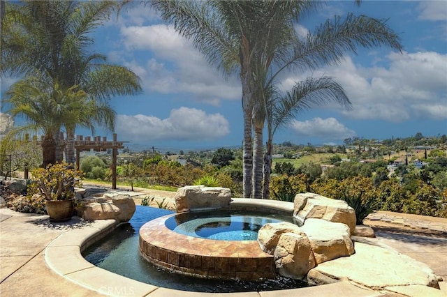 view of swimming pool featuring a pergola and an in ground hot tub