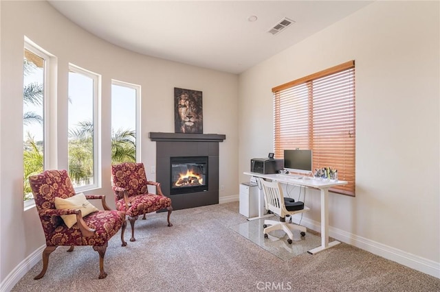 home office with visible vents, carpet, baseboards, and a fireplace